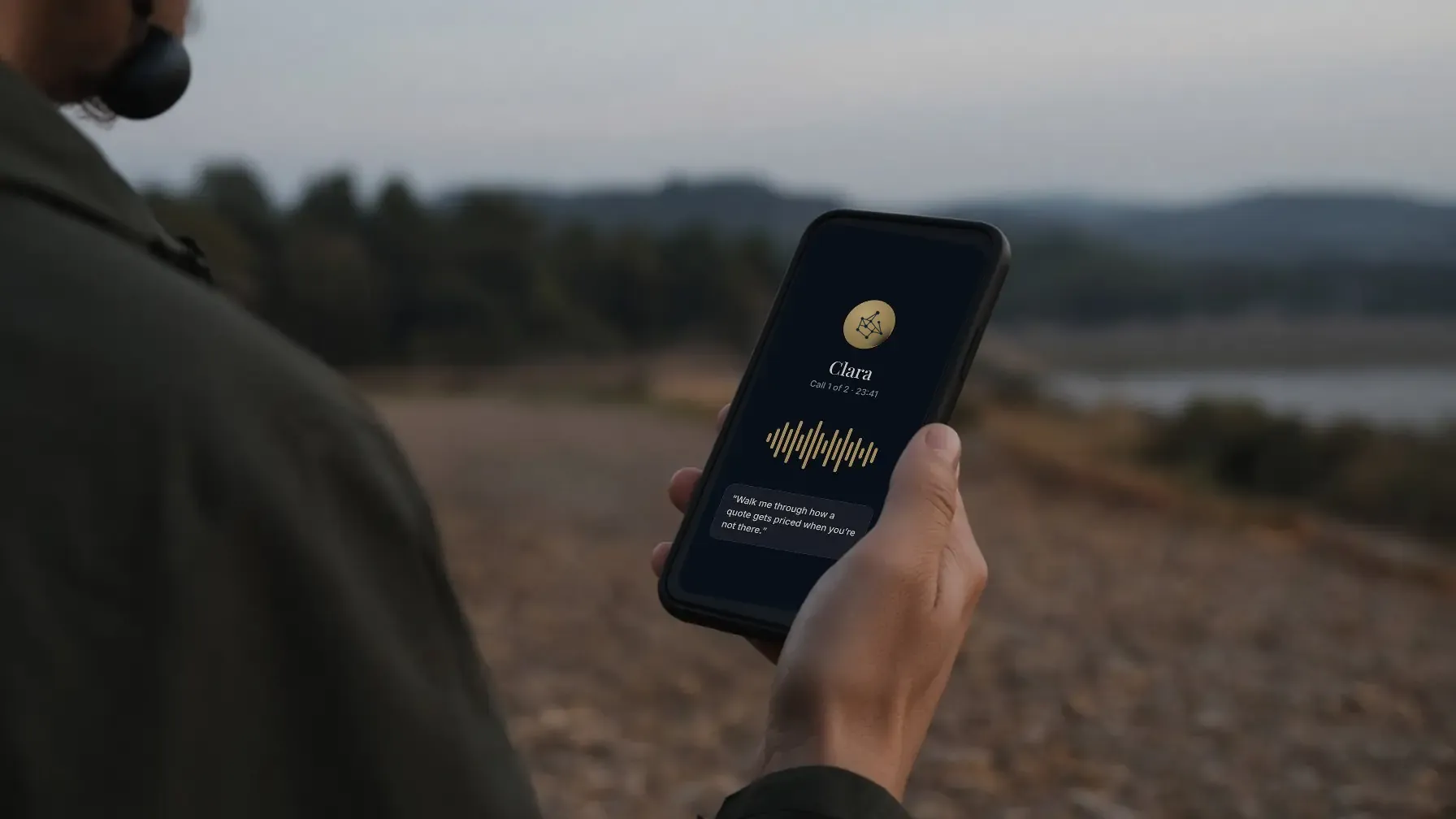A hand holding a phone on an evening walk; the screen shows a call with Clara, Call 1 of 2.